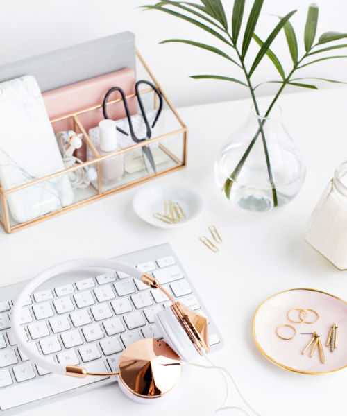 Stock Image of a blush pink styled office desktop with palms and greenery.